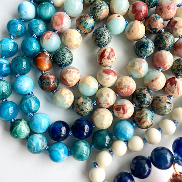 closeup of the hand knotted earthy blue and white beads