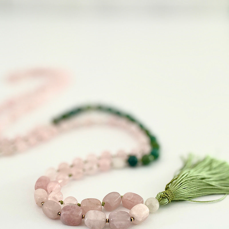 long pink, green, and gold 111 bead mala