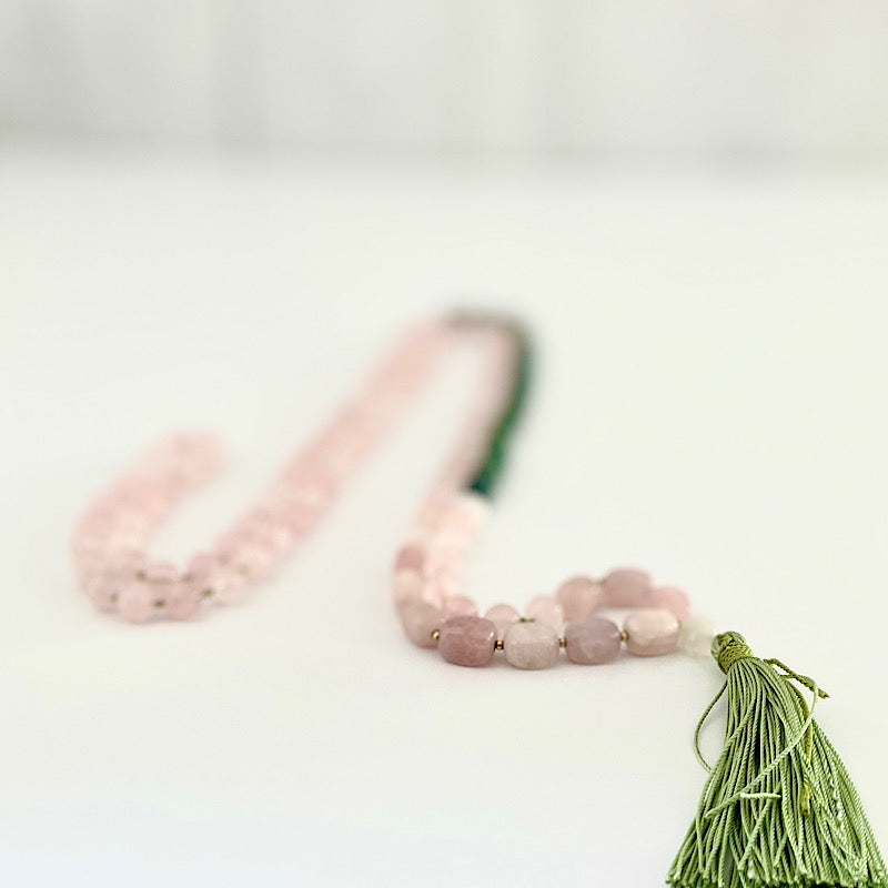 long pink, green, and gold 111 bead mala