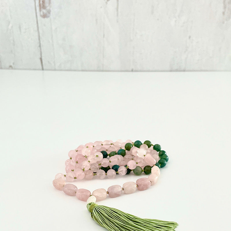 long pink, green, and gold 111 bead mala