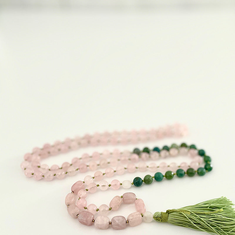 long pink, green, and gold 111 bead mala