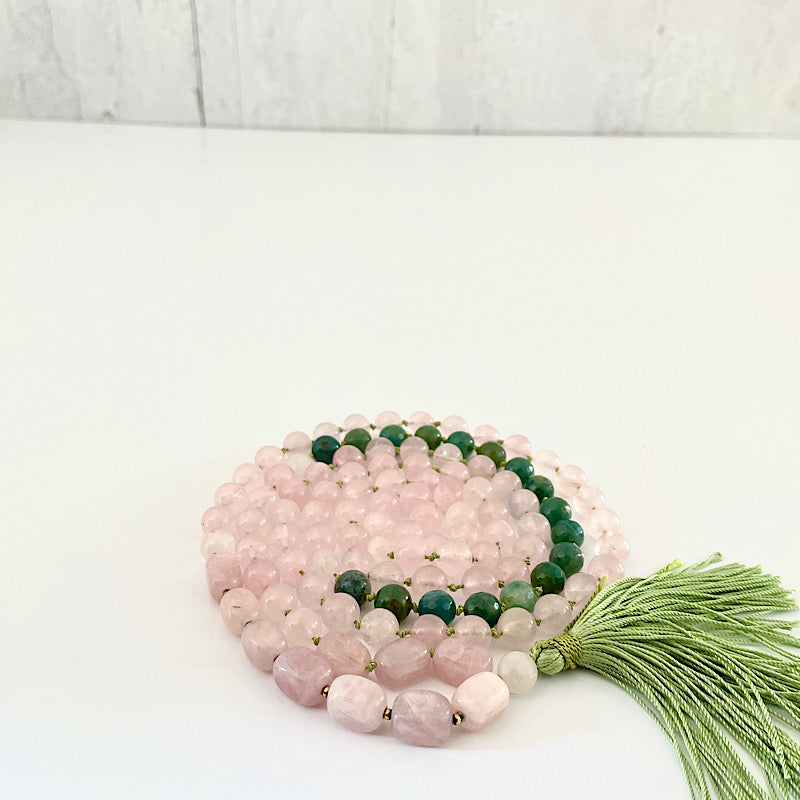 long pink, green, and gold 111 bead mala